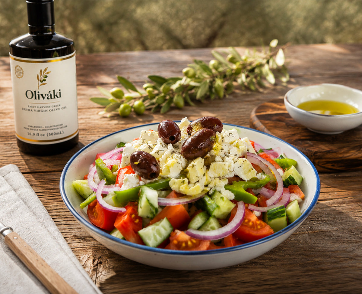 Greek salad with olives, feta cheese, tomatoes, and cucumbers served with Oliváki extra virgin olive oil.